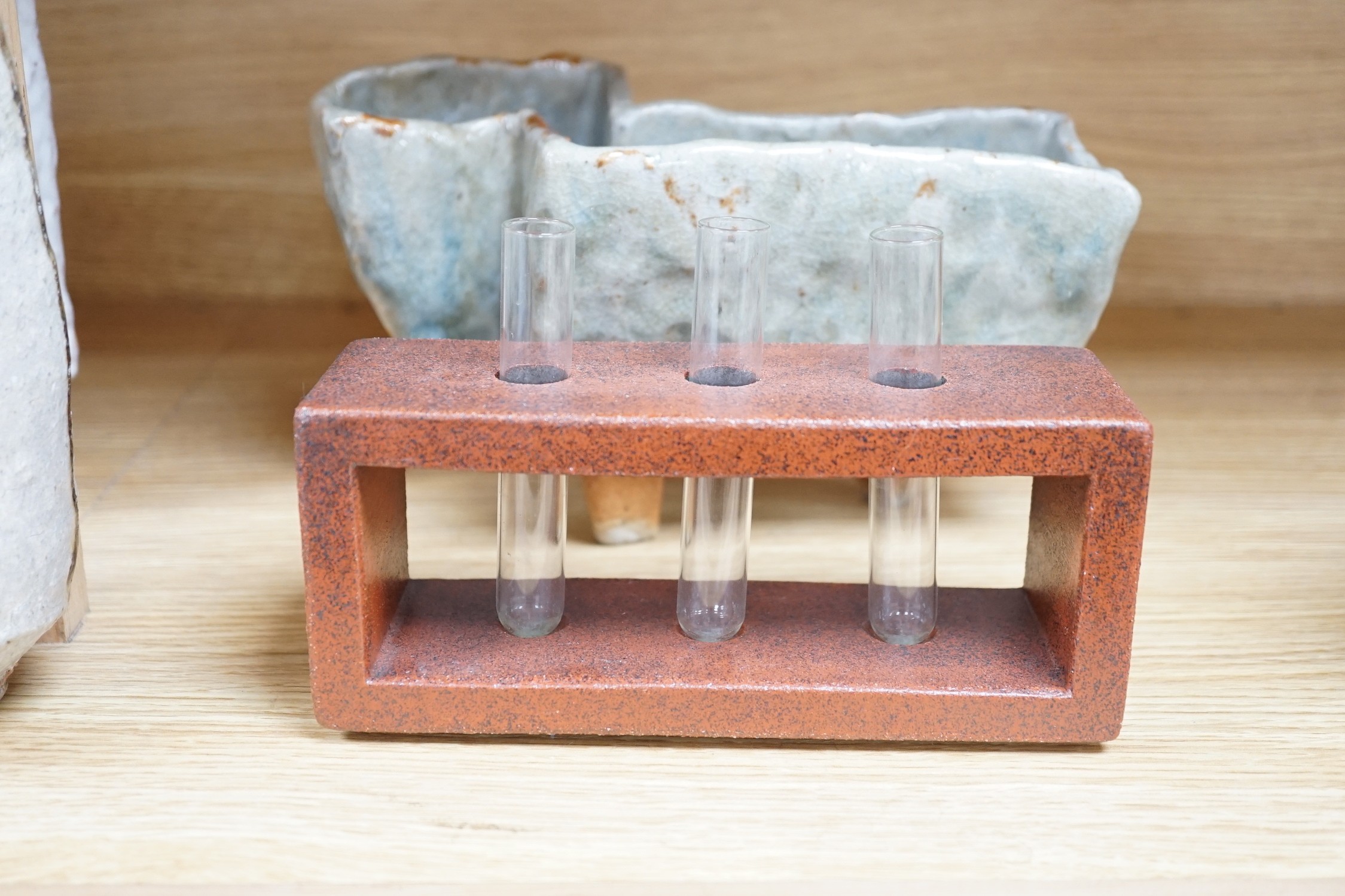 A selection of European and Japanese? studio pottery, including two glazed brick-form test tube racks, two abstract vases, and an abstract mounted slip dish, tallest 31cms high